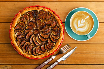 Homemade pie with pears and figs on wooden table. Top view.