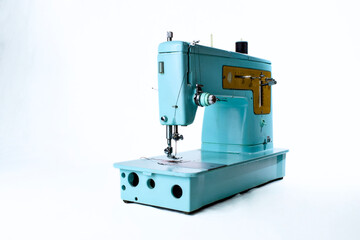 light blue vintage sewing machine on white background