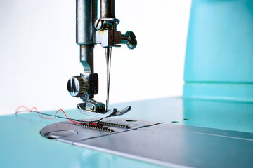 light blue vintage sewing machine on white background
