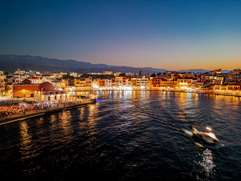 Aerial view of the illuminated Venetian Harbor embracing the K&Atilde;&frac14;c&Atilde;&frac14;k Hasan Pasha Mosque under the twilight sky, Chania, Chania, Greece.