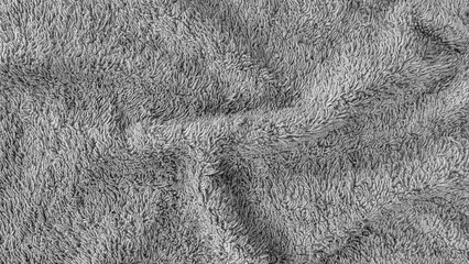 Soft and cozy gray towel fabric texture with seamless and clean background. Soft and clean gray towel with soft folds.