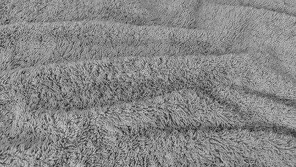 Soft and clean gray towel texture with seamless and smooth background. Wavy and wrinkled surface pattern of gray towel fabric texture.