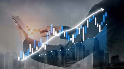 A business professional using a smartphone to analyze financial data, surrounded by graphical...