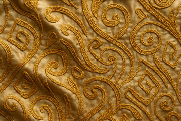 Abstract golden embroidery background on silk cloth