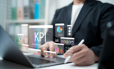 Businessman using stylus with KPI dashboard and analytics charts on laptop, representing business performance tracking, corporate management, data visualization, strategy planning and growth