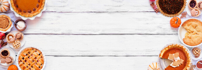 Homemade autumn pie double border. Top view on a white wood banner background with copy space. Assortment of apple, pumpkin and pecan pies.