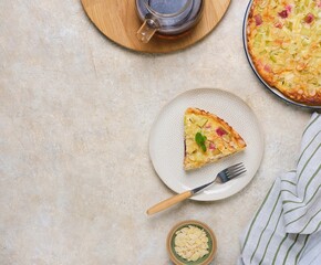 Sliced ​​shortcrust pastry tart with rhubarb, plum jam, and almonds on a round plate against a light concrete background. Rhubarb recipes.
