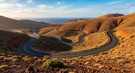 Winding Road Through Arid Mountains Towards the Ocean.