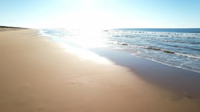 High tide timelapse on a sandy beach, showing the ocean slowly advancing and receding over the expansive shore sandy beach, sky, environment