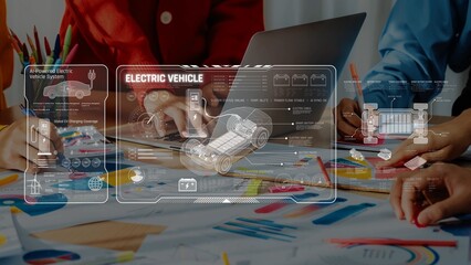 A dynamic business team collaborates in a creative workspace, analyzing electric vehicle technology using a laptop and graphic displays for innovative project planning. Raster