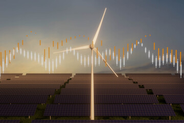 A wind turbine is in the foreground of a field of solar panels