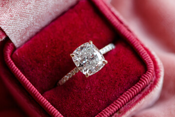 Cushion cut diamond engagement ring resting in a ring box