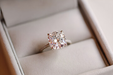 Cushion cut diamond engagement ring resting in a ring box
