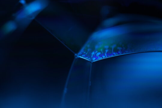 Blue liquid surface, oil stains movement, bright chemistry, surreal background, arctic blue colour, water surface, ink and water