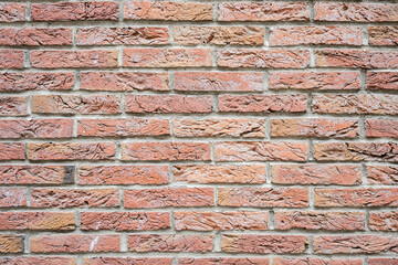 Fototapeta premium Stone wall with much brown bricks of the modern building.