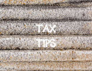 Tax tips symbol. Concept word Tax tips on beautiful grey mountain wall. Beautiful grey mountain wall background. Business tax tips concept. Copy space.