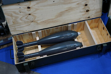 Two mortar or artillery shells in wooden box, detail from presentation at military and defense fair