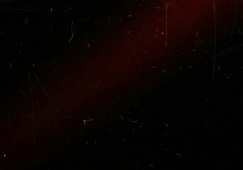 Atmospheric grunge overlay featuring cinematic dust and scratches, creating a vintage damaged film look on a dark, moody red and black surface