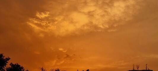 Sunset Sky Panoramic Scene with Vibrant Orange and Yellow Sky Colors. Scenic Sky Texture Background...