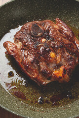fried steak, veal neck on the bone, cooking meat in a frying pan, top view, no people,