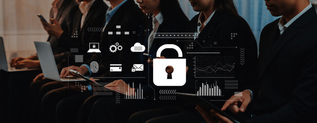 A group of business professionals focuses on cybersecurity during a conference, highlighting the...