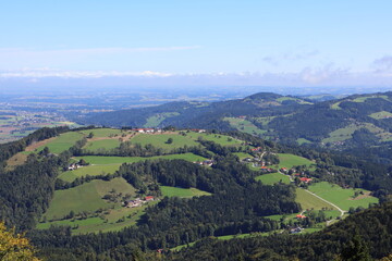 Naklejka premium Idyllic panorama of a hilly agricultural landscape, farmland scenery, rural countryside, scenic view