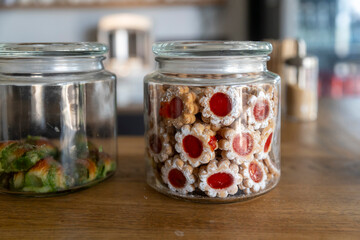 Homemade Flower-Shaped Cookies with Jam in a Glass Jar on a Wooden Table