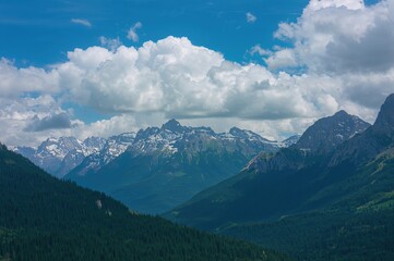 Fototapeta premium A tranquil summer journey amidst stunning natural scenery featuring snowy mountains and vibrant greenery under a cloud-dotted sky