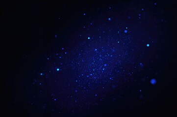 Fototapeta premium Abstract background with dark blue hues and glowing dust particles, featuring light ray effects