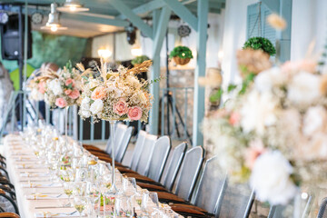 wedding table decoration.  elegant long banquet table set for a wedding reception indoors,...