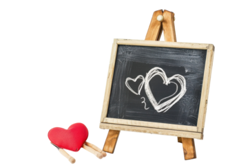 Chalkboard easel displaying lovingly drawn hearts alongside plush heart and wooden sticks, symbolizing creativity and affection isolated on transparent background