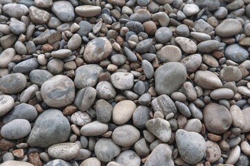 Detailed view of smooth river stones texture for backgrounds and 3D materials