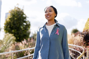 Woman wearing pink ribbon for breast cancer awareness