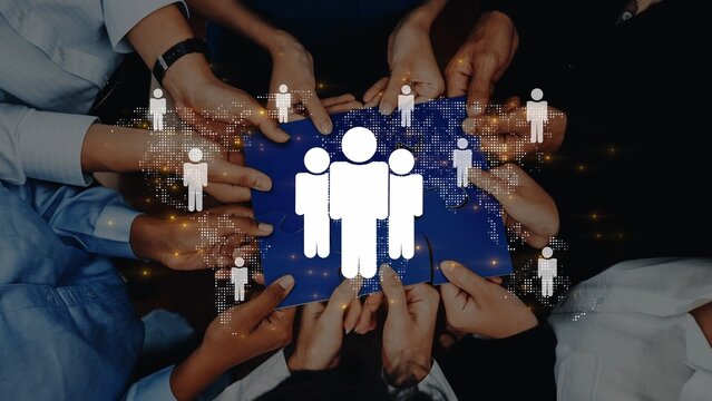 A diverse group of hands collectively holds a blue background featuring digital icons representing teamwork and unity, encapsulating collaboration in a modern environment. Raster