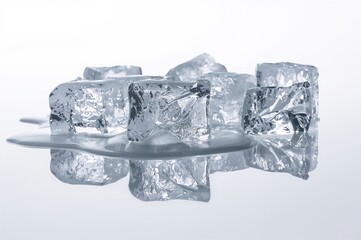 Obraz premium Cluster of Melting Ice Blocks with Reflections on a White Surface