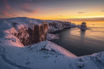 Winter twilight illuminating icy cliffs