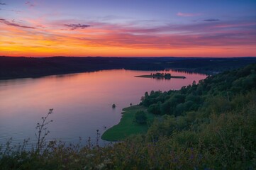 Fototapeta premium Sunset view over a tranquil lake in the evening