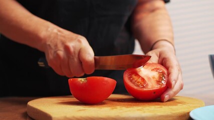 Slicing fresh tomatoes in a kitchen for a healthy meal preparation - Powered by Adobe