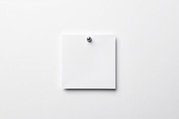 Blank note attached to white surface, viewed from above