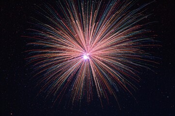 Fototapeta premium Massive blast with colorful spirals radiating outward. Bright optical fibers creating a fireworks-like display.
