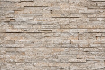Fototapeta premium Beige sandstone block arrangement showcasing rough surface for exterior wall design