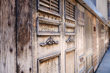 Ornate wooden panels with door and decorative barrier on a Manhattan street