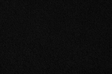 Fototapeta premium Dark textile surface. Garment backdrop. Macro shot