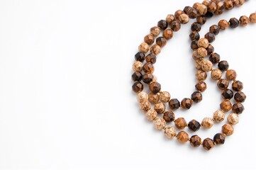 Wide backdrop with ample space featuring a brown beaded vintage necklace for women. Fashion accessory, handcrafted jewelry, beadwork.