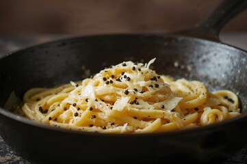 Freshly Made Cacio E Pepe Pasta Featuring Pecorino Romano and Black Pepper Served in a Cast-Iron Skillet, Shot from a Low Angle