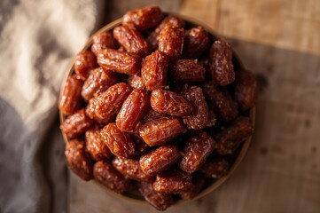 Fototapeta premium Overhead Shot of a Heap of Delicious Honey-Glazed Dried Dates Spread Out on a Surface