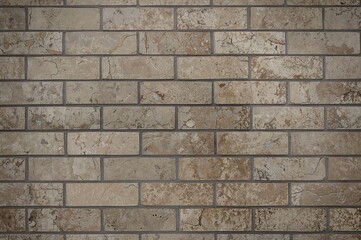 Fototapeta premium Close-up texture of a rough granite stone wall surface