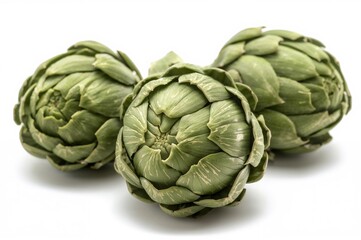 Obraz premium Isolated fresh green artichokes on a white backdrop. Naturally cultivated.
