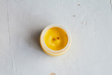 colorful acrylic paint in jar, grey dirty background,  artists materials photography