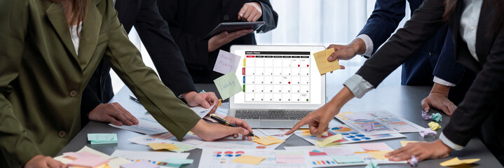 Analyst team use sticky note for creative and analytic brainstorm for business idea with BI data dashboard on laptop screen. Analysis financial data visualization tech for marketing strategy. Prodigy